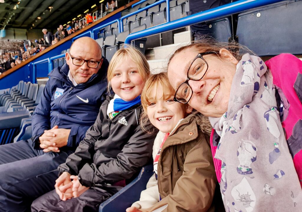 Simona, Will and their children Sophie & Flo at a football match together before receiving support from the Ruth Strauss Foundation.