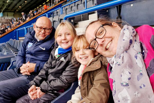 Simona, Will and their children Sophie & Flo at a football match together before receiving support from the Ruth Strauss Foundation.